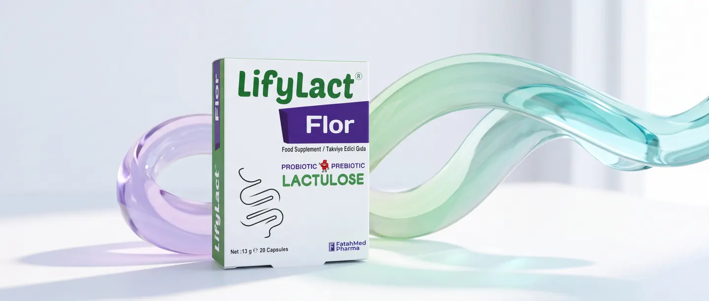 Lavanda, yaşıl və firuzəyi rənglərdə axan şüşə lentin yanında LifyLact Flor qutusu